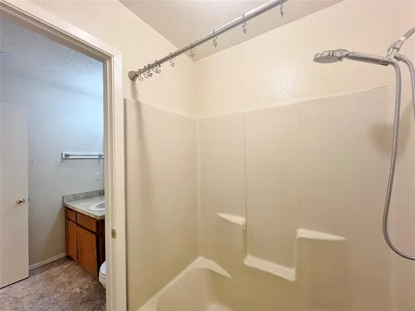 a bathroom with a shower and a toilet