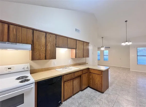 a kitchen that has a sink and a stove in it