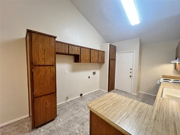 a bedroom with a bed and a refrigerator