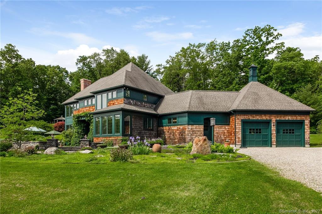 a front view of a house with a yard table and chairs
