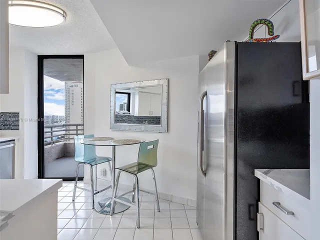 a kitchen with stainless steel appliances a refrigerator and a stove top oven
