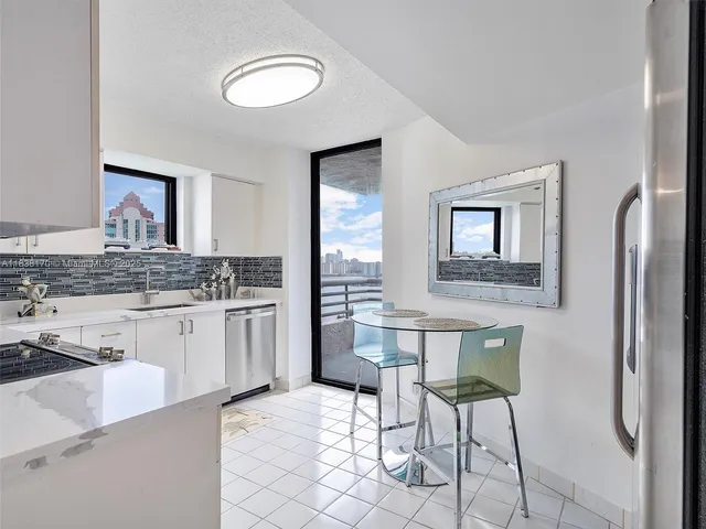 a kitchen with a refrigerator and cabinets