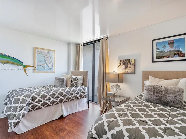 a bedroom with a large bed and a lamp