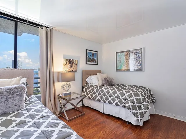 a bedroom with a bed lamp and a window