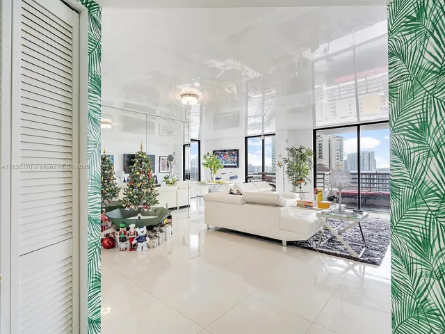 a living room with furniture and a potted plant