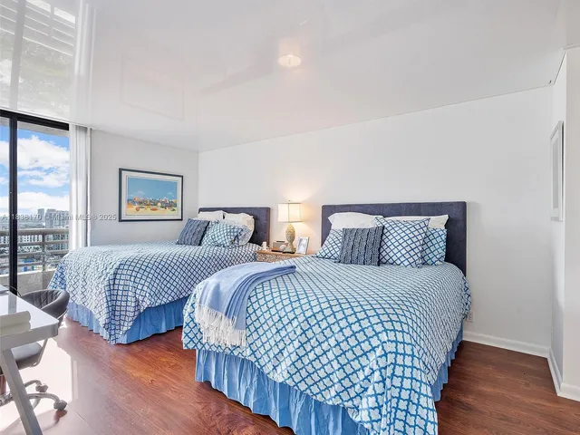 a bedroom with two beds and a night stand