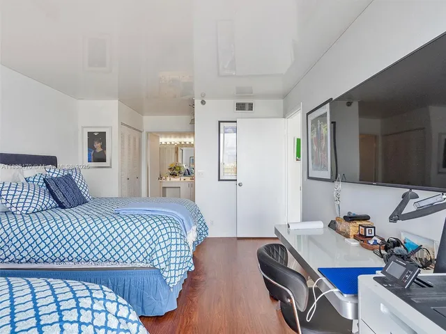 a bedroom with a bed and a desk