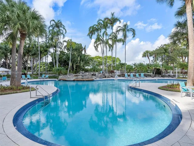 a view of swimming pool with outdoor seating and plants