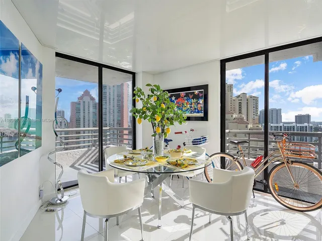 a dining room with furniture a flat screen tv and a large window