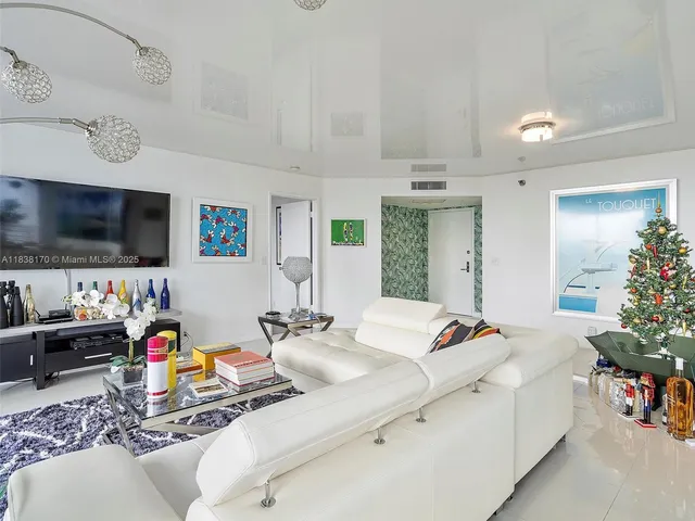 a bedroom with furniture and a flat screen tv