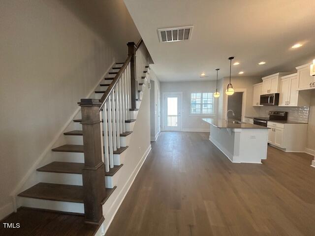 8524 Silsbee Drive Raleigh, NC 27613 - Photo 3 of 15 a view of kitchen and hall with wooden floor