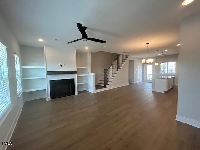 8524 Silsbee Drive Raleigh, NC 27613 - Photo 6 of 15 an empty room with windows and fireplace
