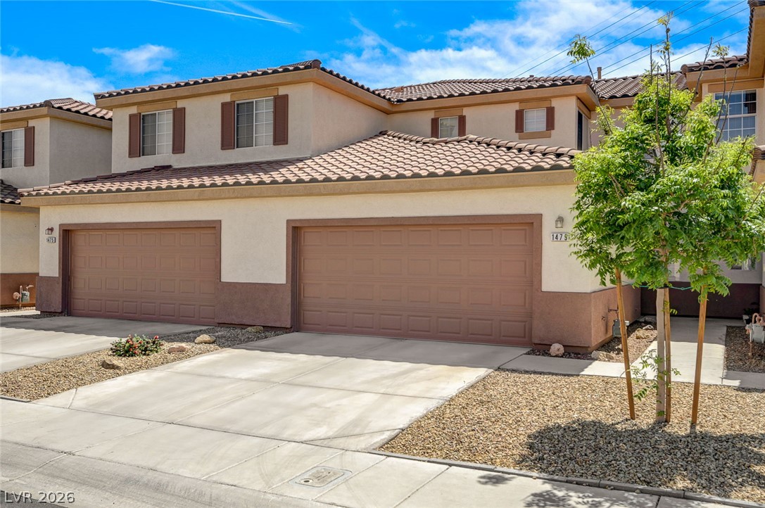 1479 Orange Jubilee Road Henderson, NV 89014 - Photo 30 of 36 A classic tiled roof and neutral stucco facade welcome you to this charming two-story townhome.