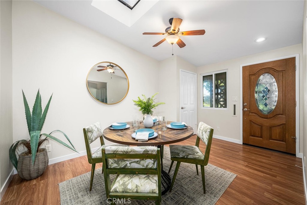 1240 Oakmont Road, Unit 52I Seal Beach, CA 90740 - Photo 13 of 33 a dining room with furniture potted plants and wooden floor