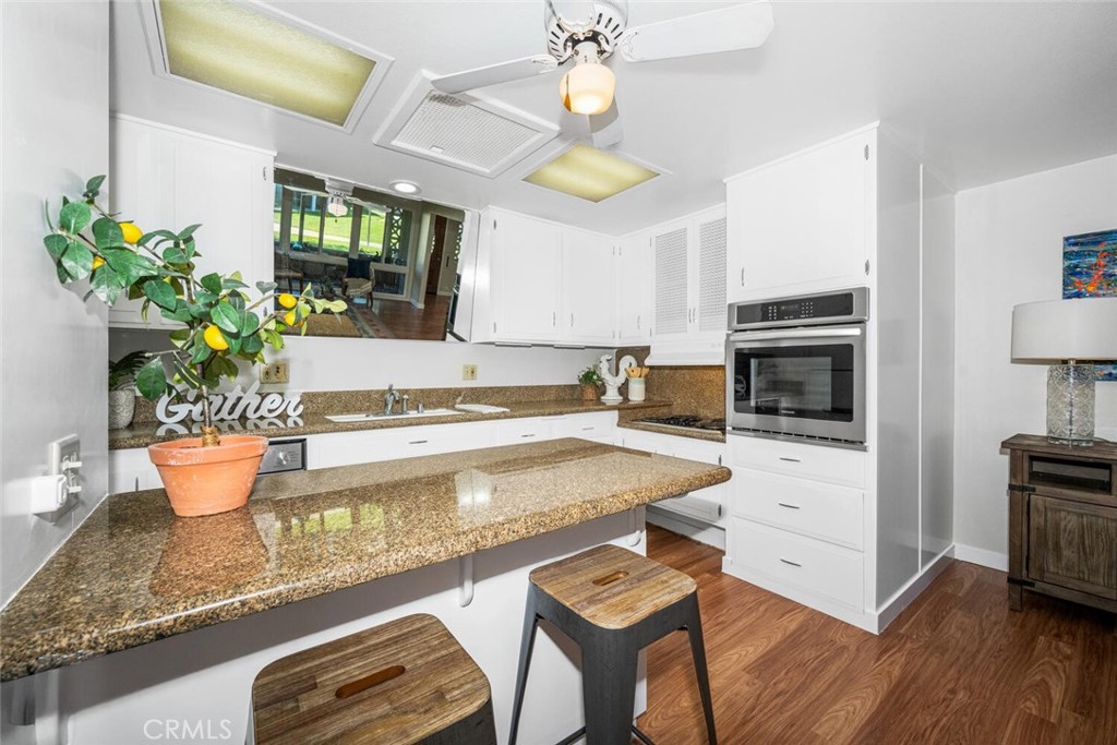 1240 Oakmont Road, Unit 52I Seal Beach, CA 90740 - Photo 19 of 33 a view of a kitchen with dining table and chairs
