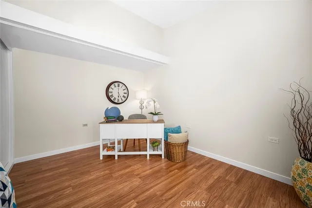 a view of a room with a wooden floor and a table