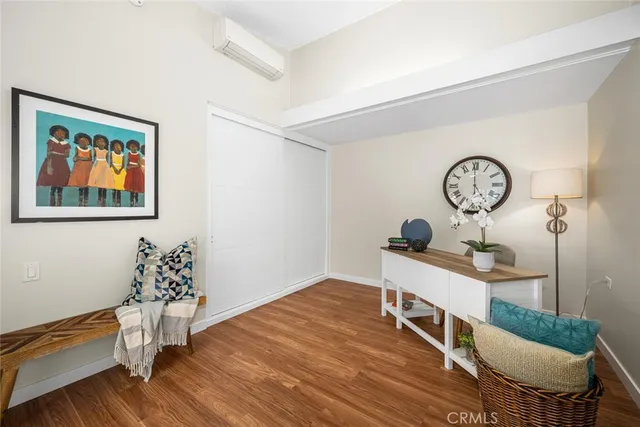 a living room with furniture a clock on wall and a table