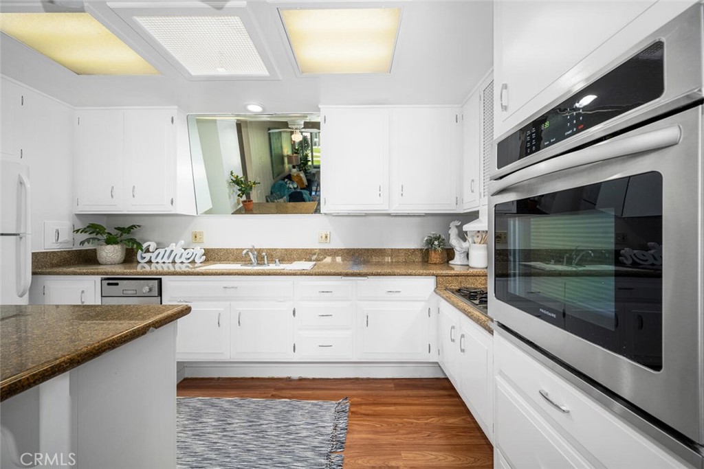 1240 Oakmont Road, Unit 52I Seal Beach, CA 90740 - Photo 23 of 33 a kitchen with stainless steel appliances granite countertop a stove and a sink