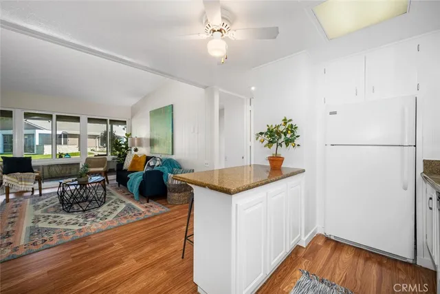 a kitchen with stainless steel appliances granite countertop a refrigerator a sink and a stove