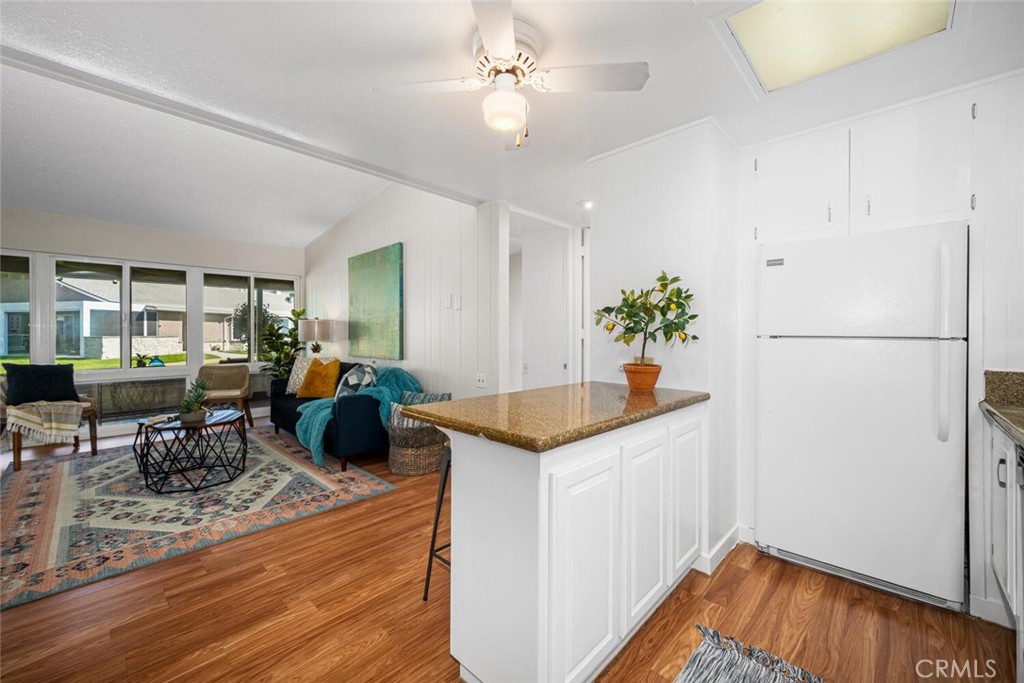 1240 Oakmont Road, Unit 52I Seal Beach, CA 90740 - Photo 24 of 33 a kitchen with stainless steel appliances granite countertop a refrigerator a sink and a stove