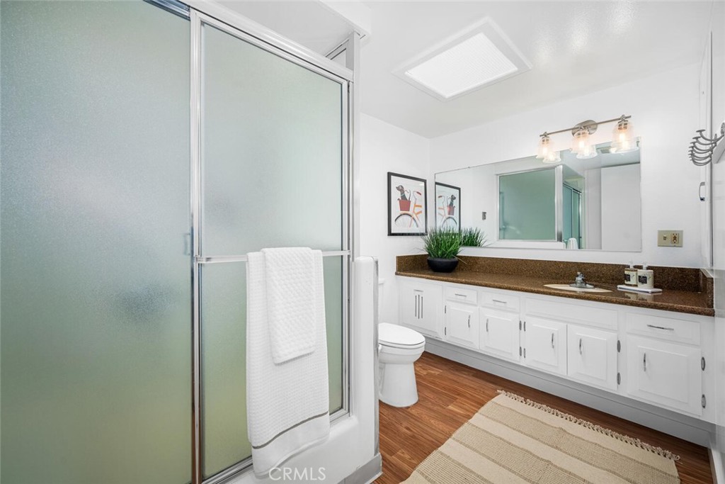 1240 Oakmont Road, Unit 52I Seal Beach, CA 90740 - Photo 27 of 33 a bathroom with a double vanity sink and a mirror