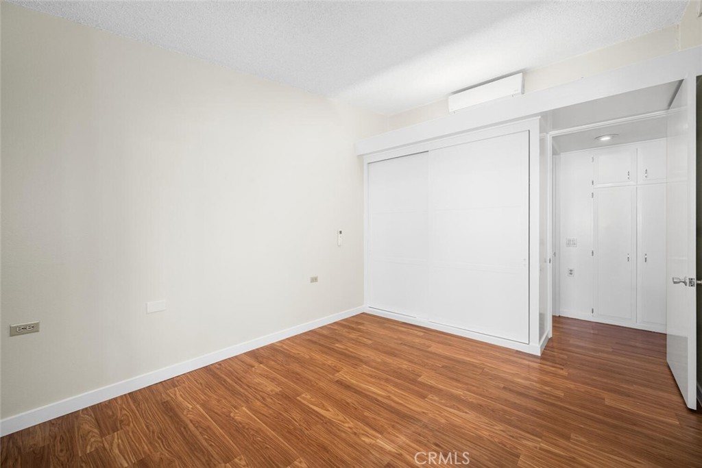 1240 Oakmont Road, Unit 52I Seal Beach, CA 90740 - Photo 29 of 33 a view of an empty room with wooden floor