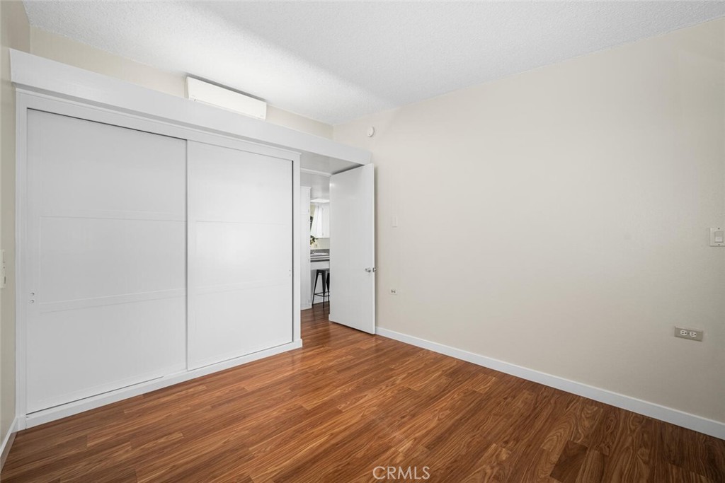 1240 Oakmont Road, Unit 52I Seal Beach, CA 90740 - Photo 30 of 33 a view of an empty room with wooden floor