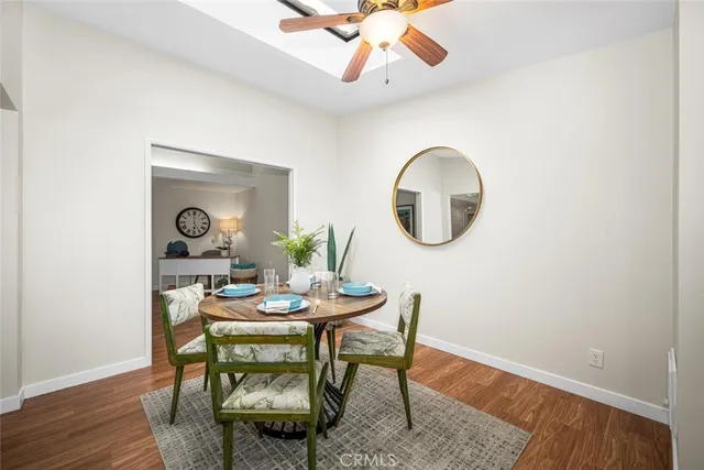 a dining room with furniture and a mirror
