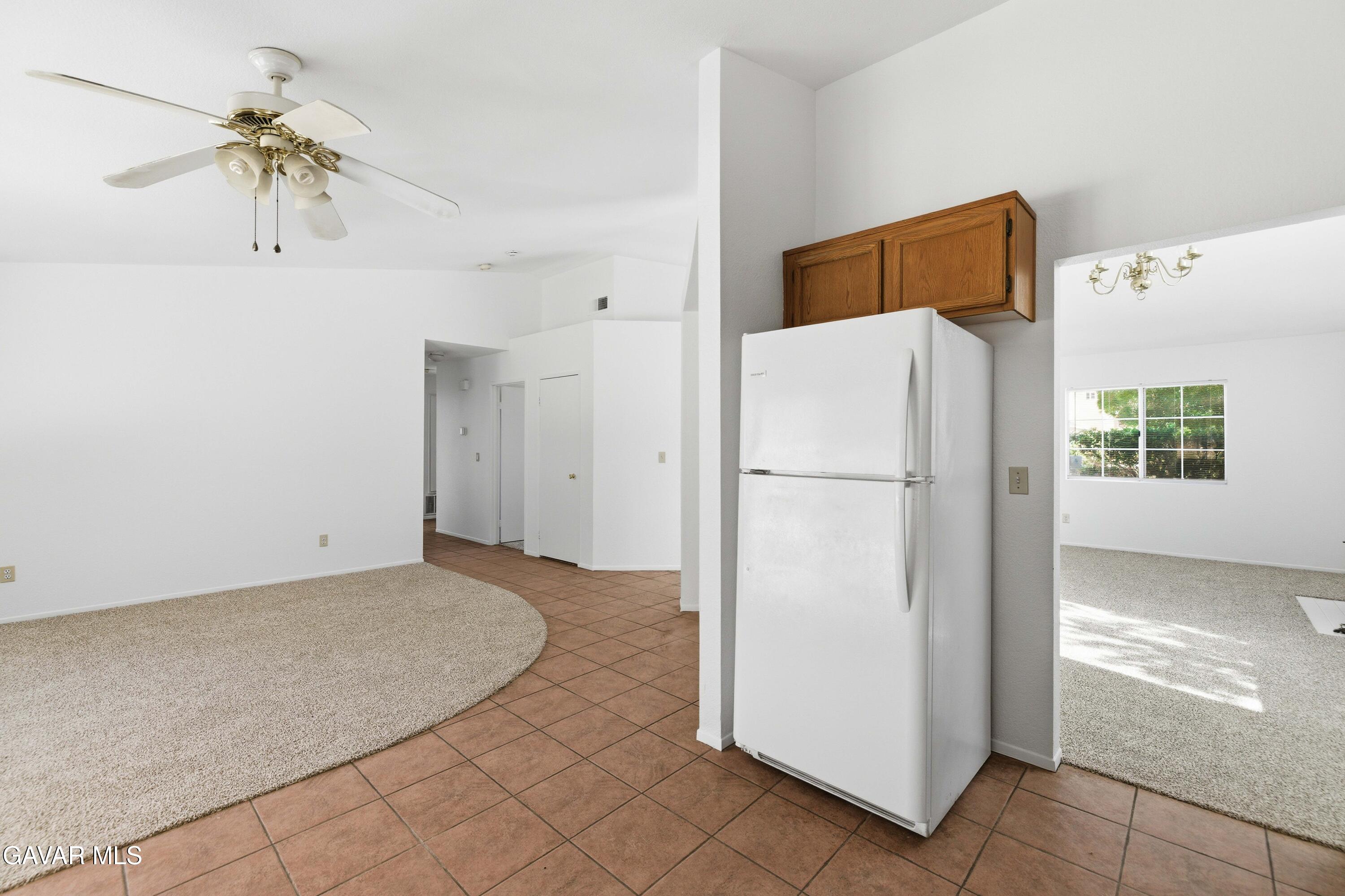 3254 Quarry Road Palmdale, CA 93550 - Photo 11 of 30 a view of a kitchen with a refrigerator and microwave