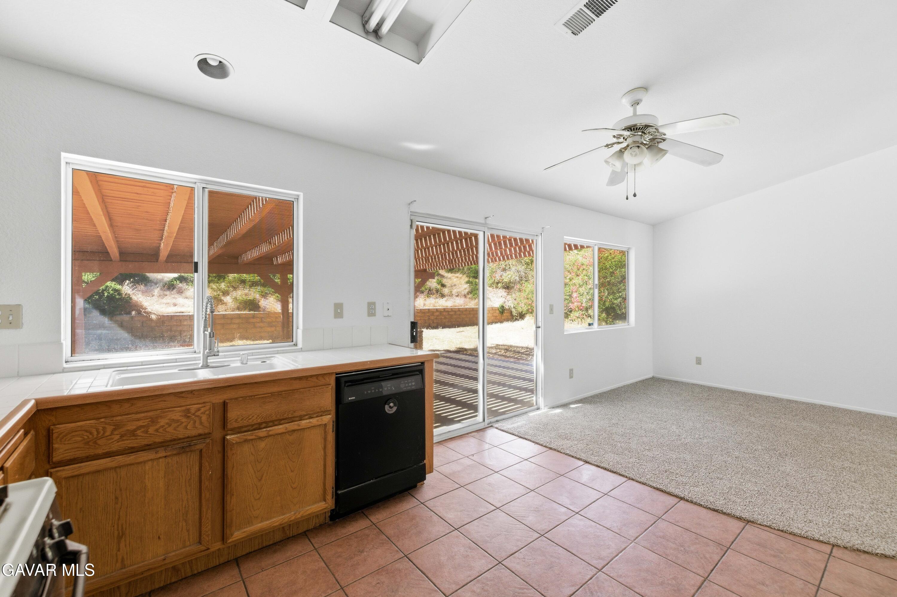 3254 Quarry Road Palmdale, CA 93550 - Photo 9 of 30 a large white kitchen with a large window