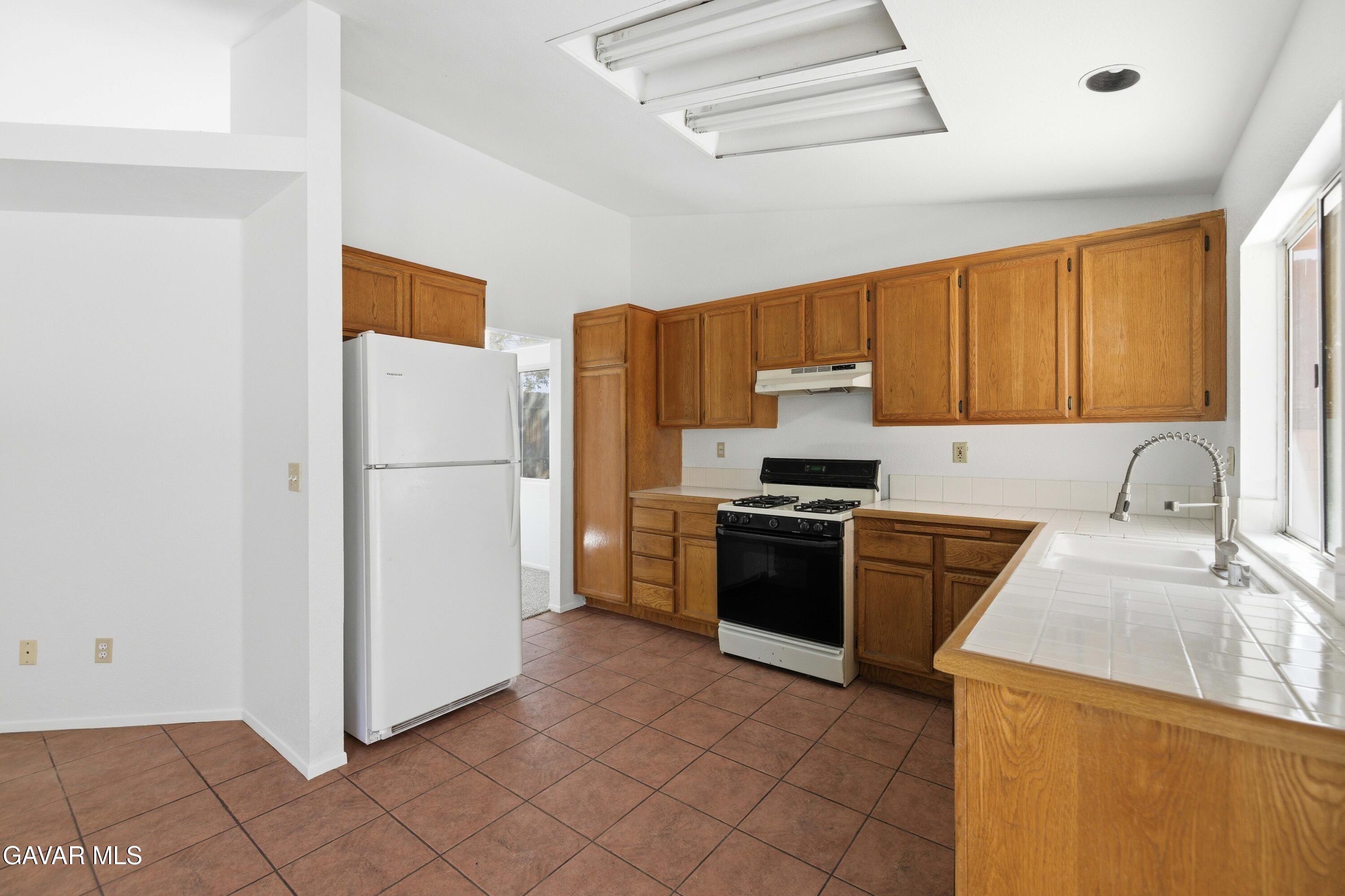 3254 Quarry Road Palmdale, CA 93550 - Photo 10 of 30 a kitchen with a refrigerator sink and stove