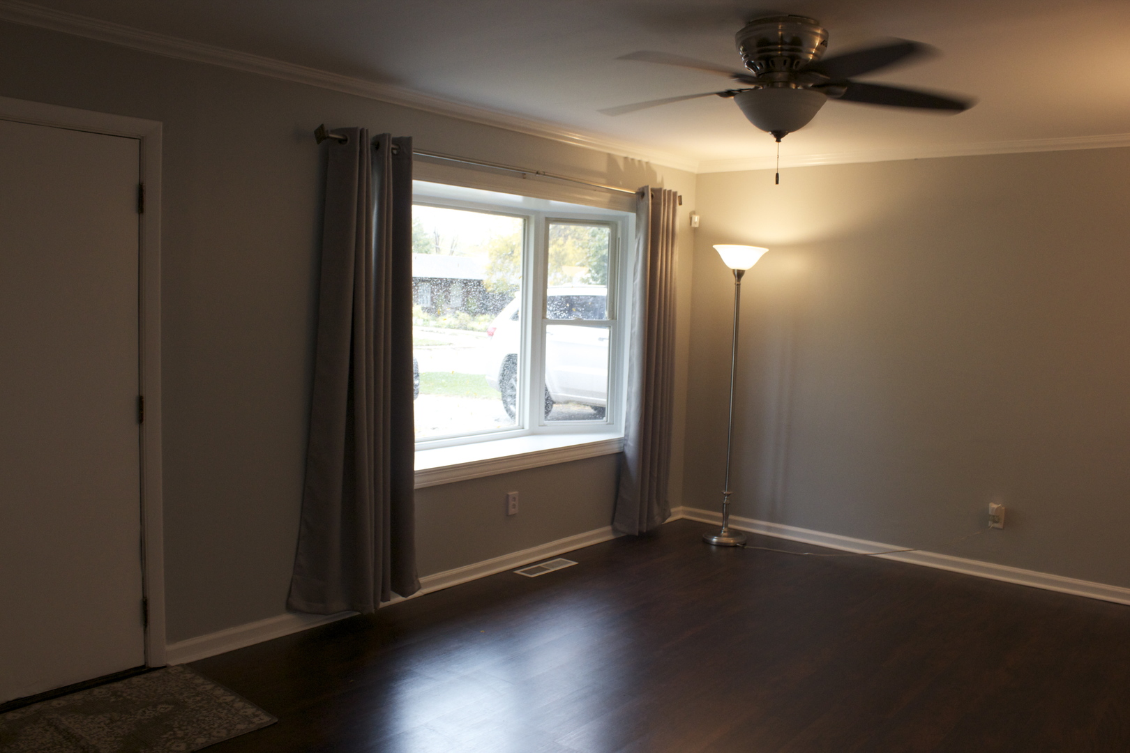 57 Springdale Road Montgomery, IL 60538 - Photo 3 of 19 an empty room with wooden floor fan and windows