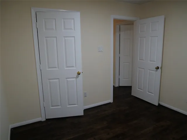 an empty room with wooden floor