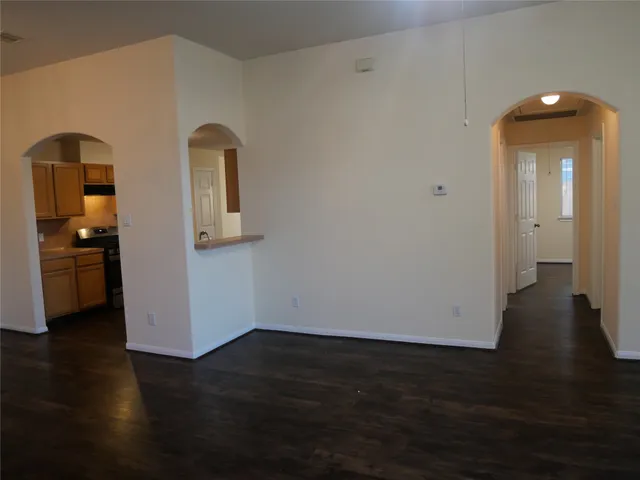a view of a room with wooden floor and a bathroom