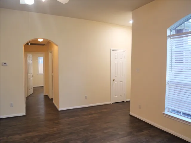 a view of a room with wooden floor and a window