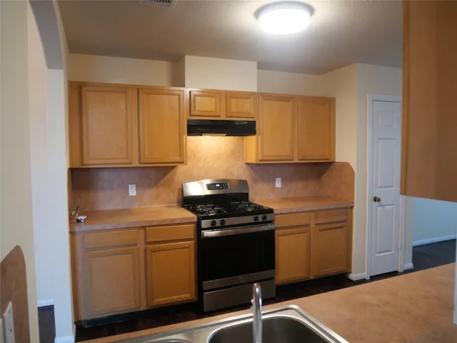 a kitchen with a sink and cabinets