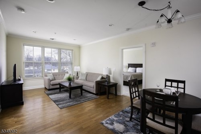 545 Morris Avenue, Unit 213 Summit, NJ 07901 - Photo 3 of 8 a living room with furniture and a window