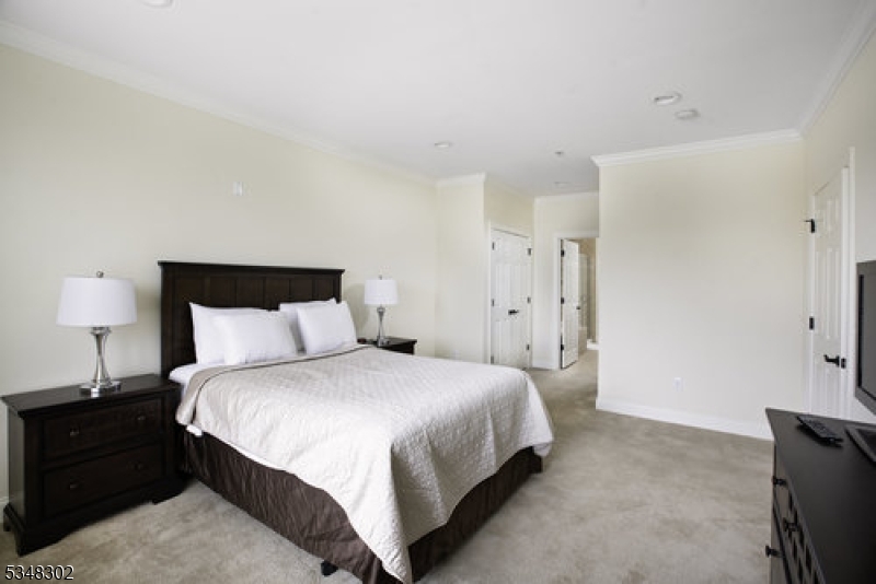 545 Morris Avenue, Unit 213 Summit, NJ 07901 - Photo 4 of 8 a bedroom with a bed and a lamp