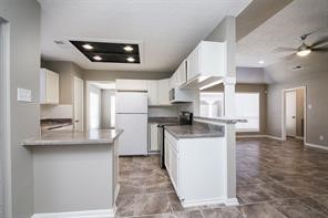 16907 Amidon Drive Spring, TX 77379 - Photo 11 of 13 a kitchen with stainless steel appliances granite countertop a sink a stove and a refrigerator