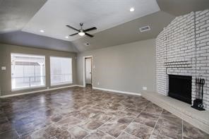 16907 Amidon Drive Spring, TX 77379 - Photo 7 of 13 a view of an empty room with a fireplace and a window
