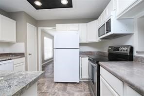 16907 Amidon Drive Spring, TX 77379 - Photo 10 of 13 a kitchen with stainless steel appliances granite countertop a refrigerator a stove and a sink
