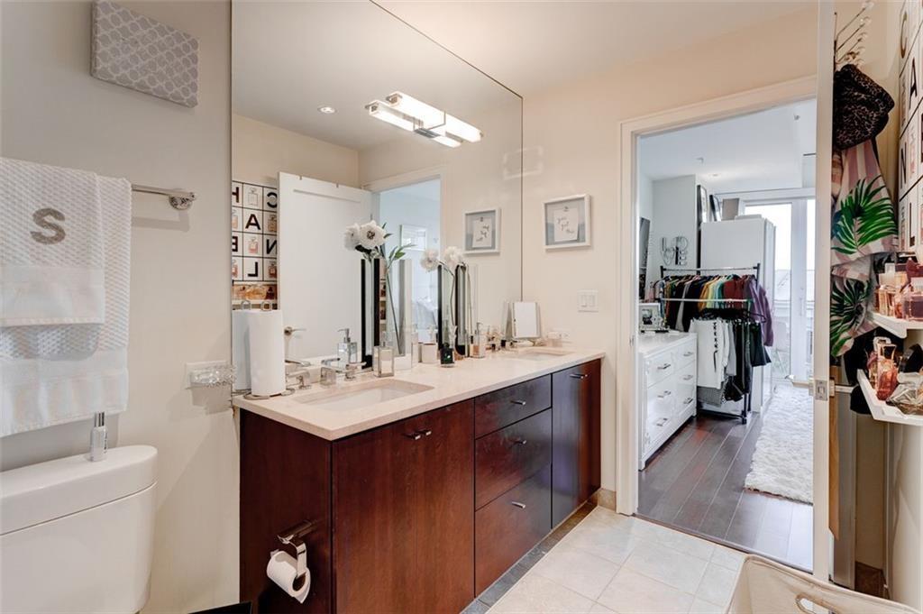 3325 Piedmont Road Northeast, Unit 1509 Atlanta, GA 30305 - Photo 15 of 29 a bathroom with a sink vanity granite and a mirror