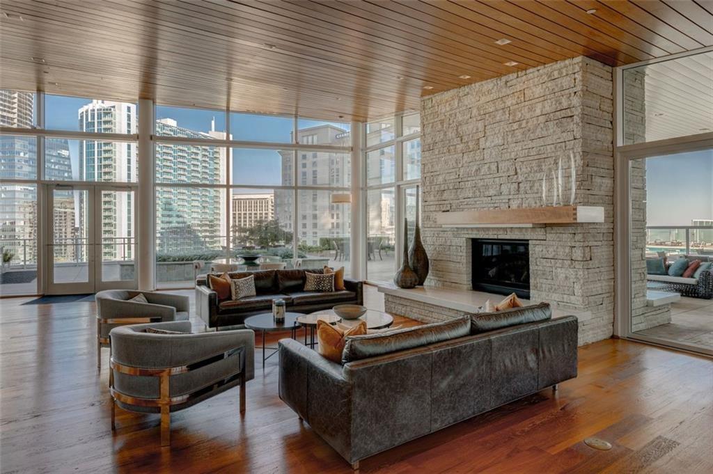 3325 Piedmont Road Northeast, Unit 1509 Atlanta, GA 30305 - Photo 24 of 29 a living room with furniture wooden floor and a fireplace