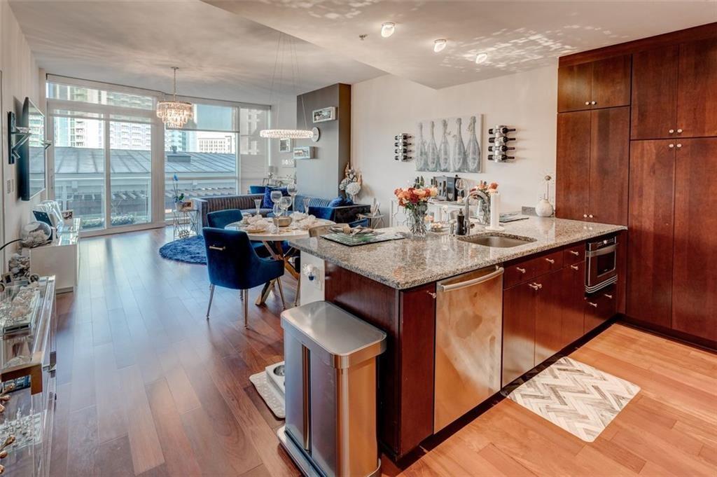 3325 Piedmont Road Northeast, Unit 1509 Atlanta, GA 30305 - Photo 7 of 29 a kitchen with stainless steel appliances granite countertop a sink a stove and a refrigerator