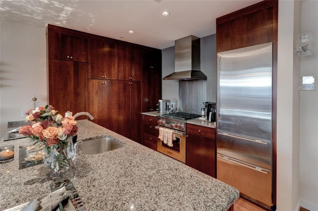3325 Piedmont Road Northeast, Unit 1509 Atlanta, GA 30305 - Photo 8 of 29 a kitchen with stainless steel appliances granite countertop a refrigerator and a sink