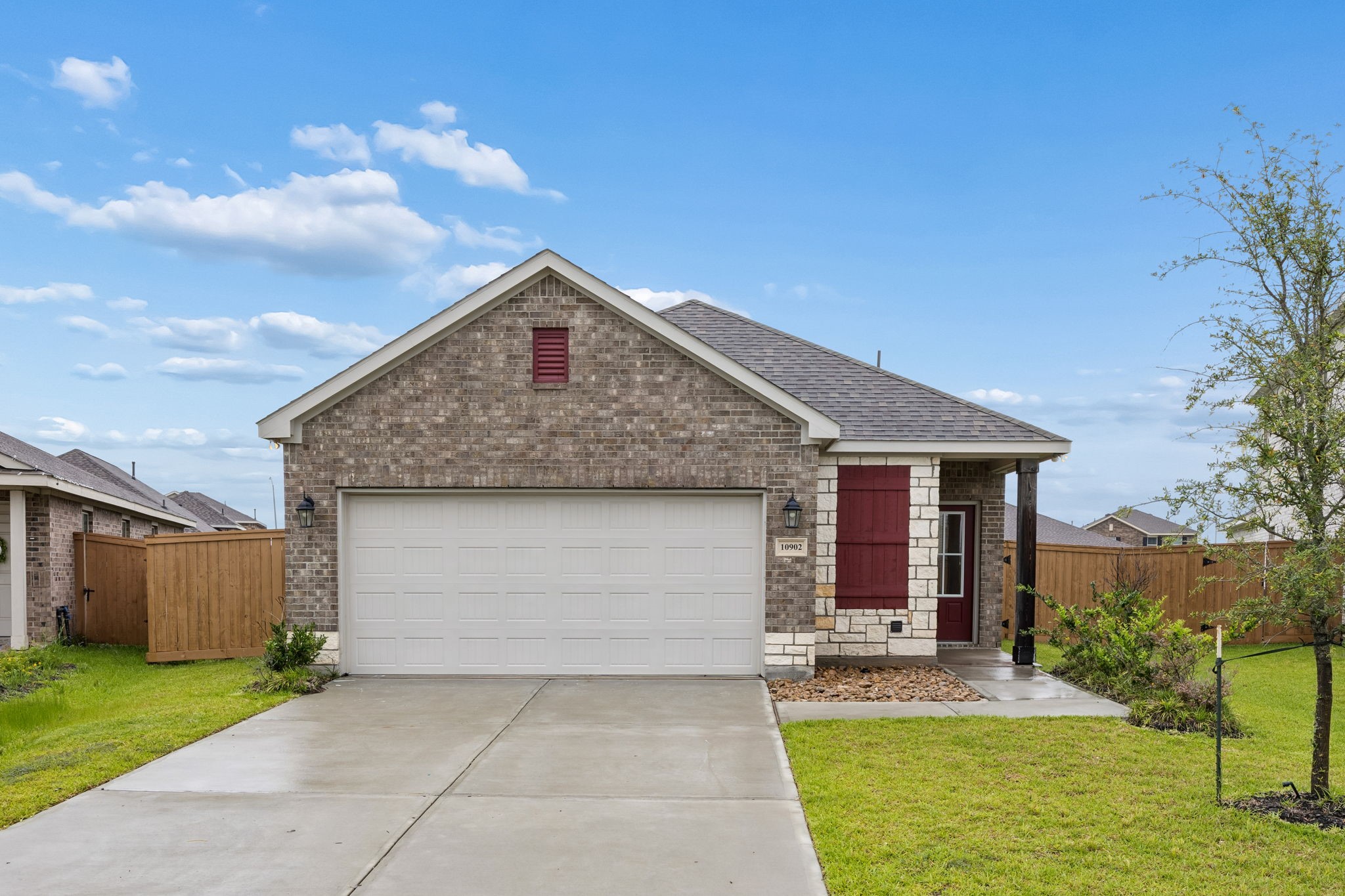 This charming single-story home features a brick exterior with a welcoming front porch, a two-car garage, and a neatly landscaped front yard. Ideal for those seeking a cozy and inviting neighborhood setting.