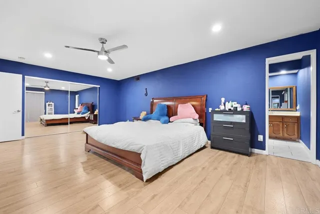 a bedroom with a large bed and a chandelier