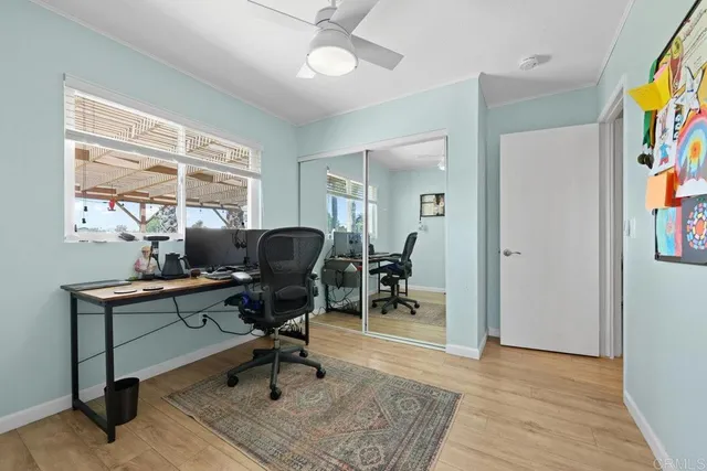 a view of a workspace with furniture and a window