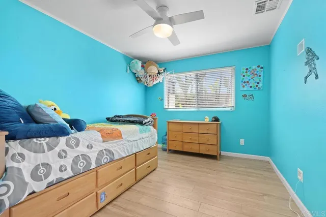 a bedroom with a bed and a dresser