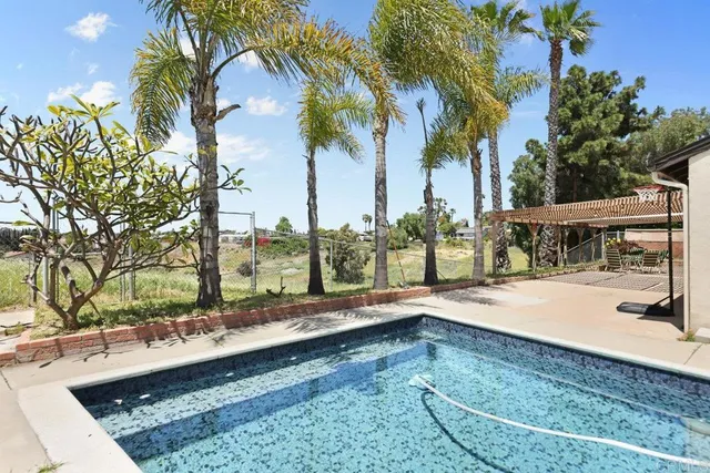 a view of a backyard patio and swimming pool